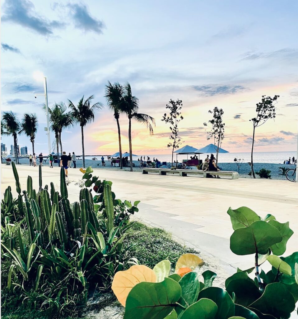 Beira Mar promenade at sunset in Fortaleza, with palm trees, coastal gardens and people along the waterfront